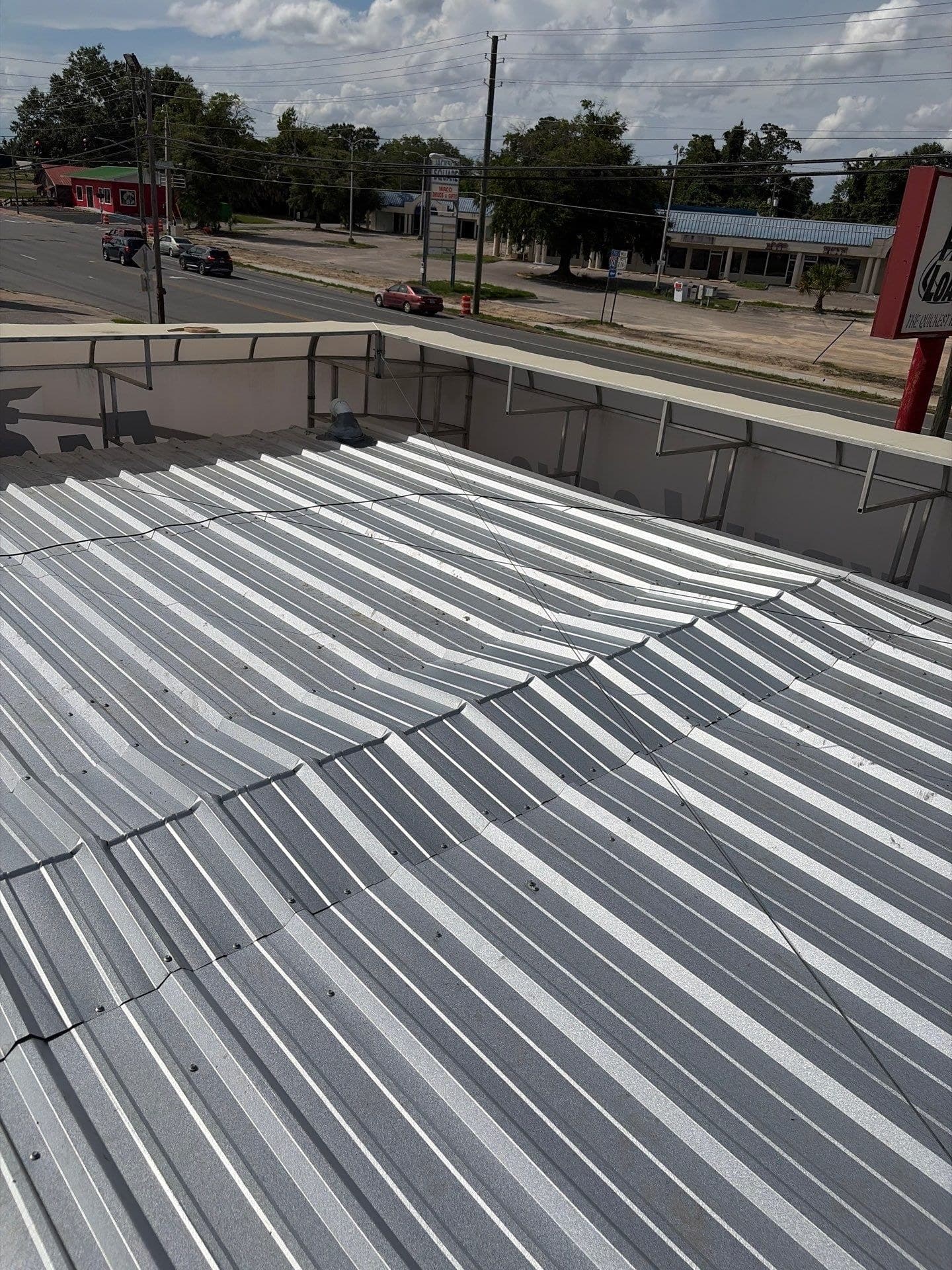 Finished metal panel roof over the storefront