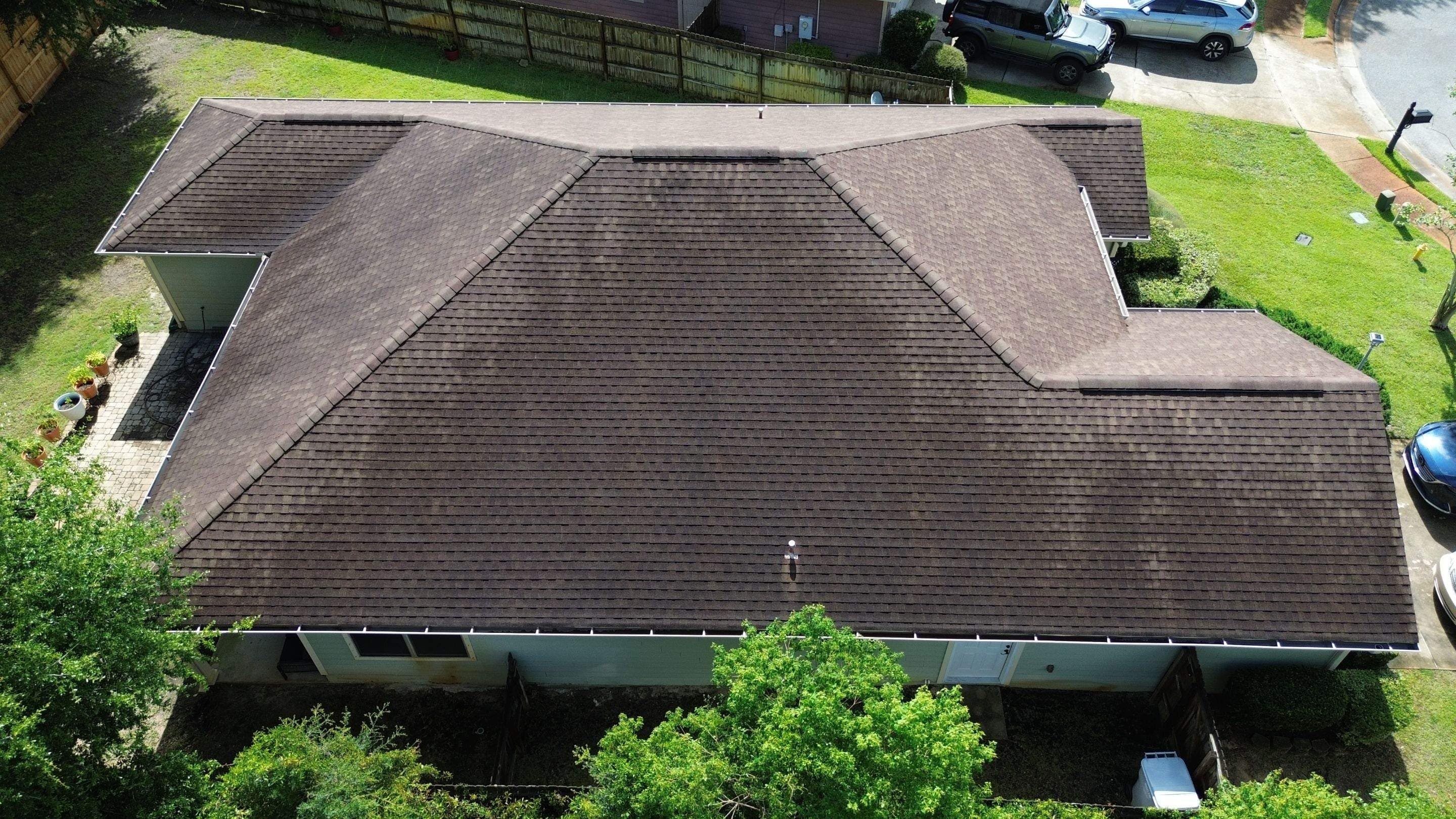 Aged, algae-streaked shingle roof before replacement, from above