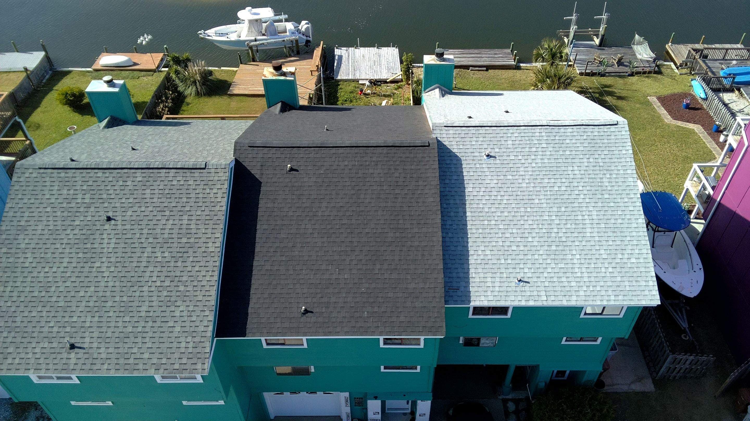 Completed shingle roof on a waterfront townhouse, seen from the water side