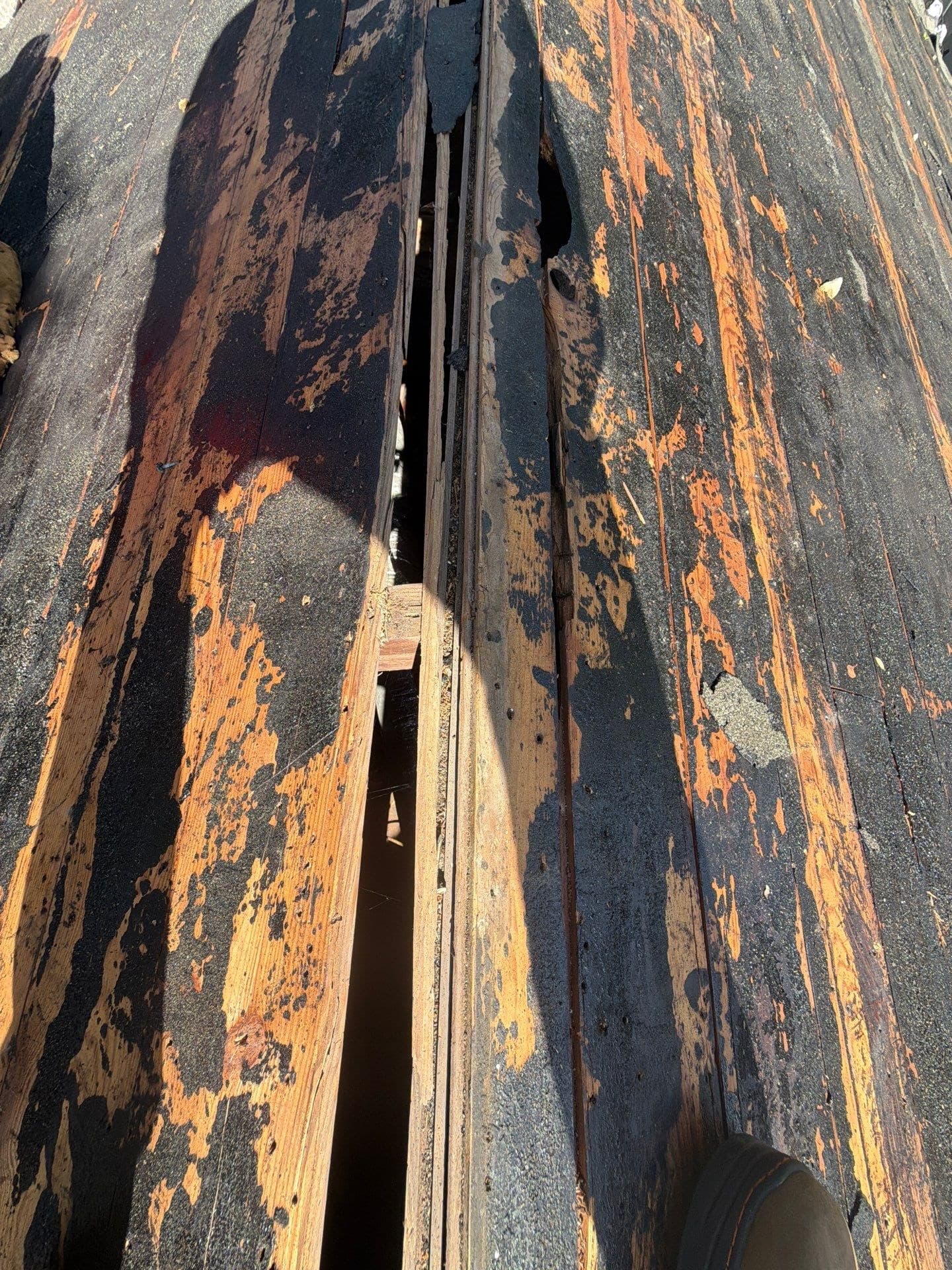Deteriorated plank decking exposed during a roof tear-off